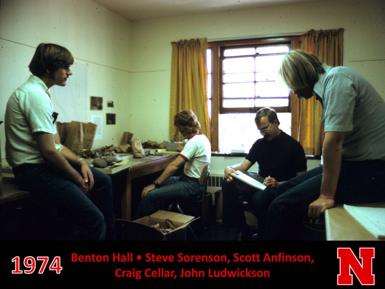 Student working in Benton Hall with collections in 1974