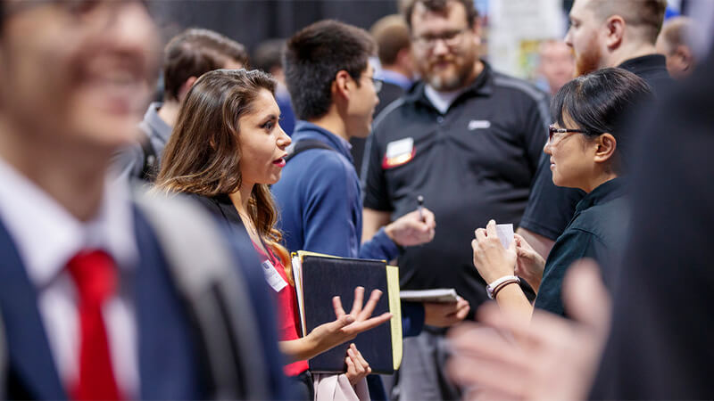 Students meeting with prospective employers at career fair