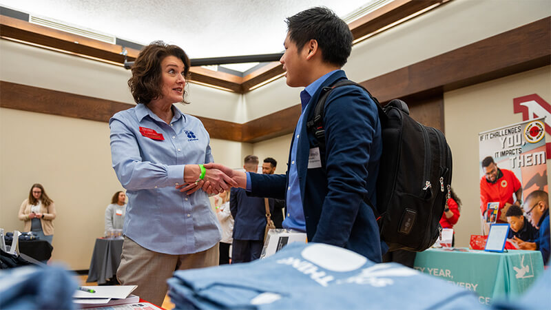 Student shaking hands with prospective employer at Career Fair