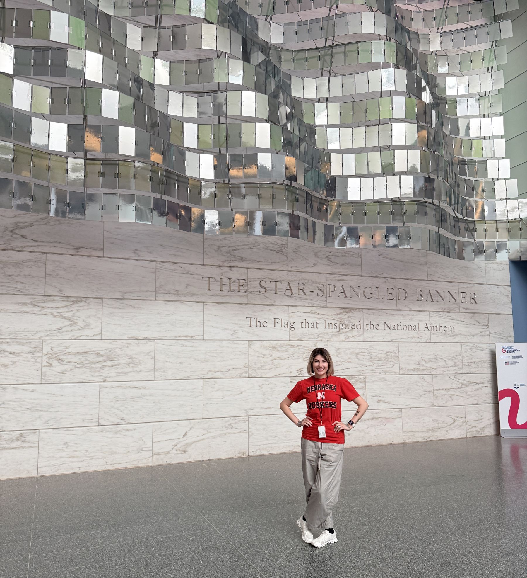 Catherine Day next to a Star-Spangled Banner display