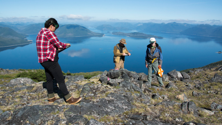 Researchers (from left) Elizabeth Howard, Mike Chondoronek and Ralph Hartley record initial observations of an Alaskan alpine cairn.