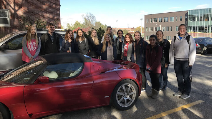 Students around a Tesla Roadster