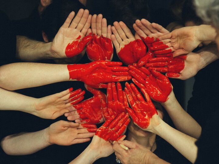 Hands forming a painted heart